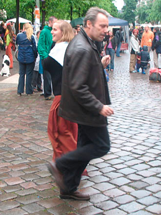 Hugh Featherstone and Kimbastian dancing in the rain at Weltfest, Berlin