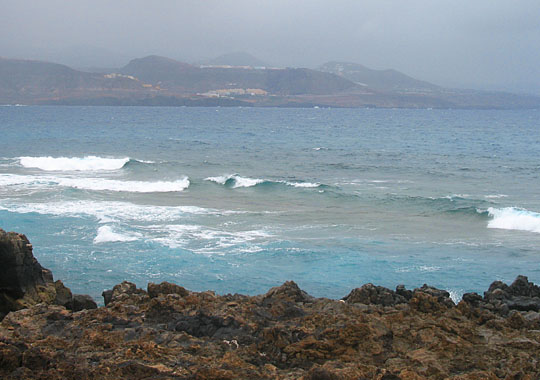 Crashing waves and distant hills on Isla Afortunada at The Cheshire Cat Blog