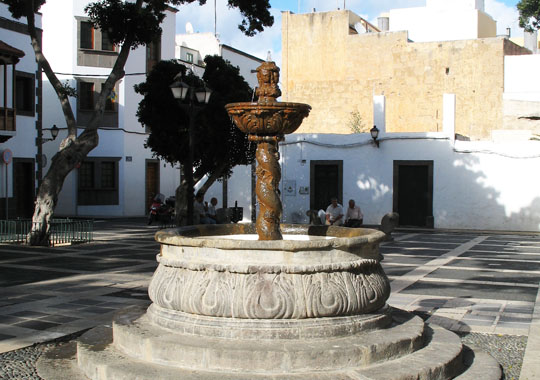 Old fountain on a plaza in Afortunada at The Cheshire Cat Blog