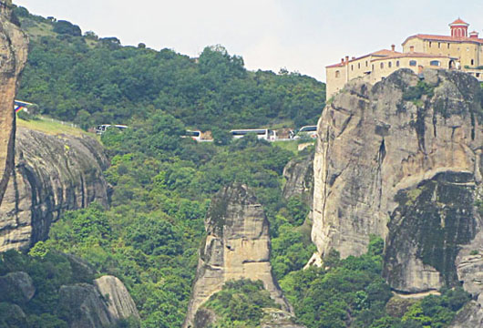 Tour bus convoy parked outside the monstery of Agios Stefanos, Meteora, Greece at The Cheshire Cat Blog
