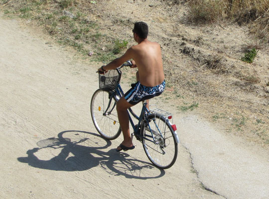 Cyclist on the beach at The Cheshire Cat Blog