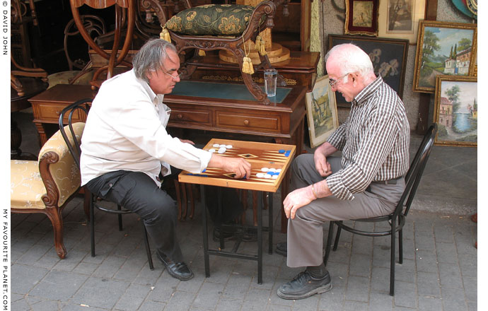 Athenian stall holders playing tavli (backgammon) at the Flea Market, Monastiraki, Athens at The Cheshire Cat Blog Athenian stall holders playing tavli (backgammon) at the Flea Market, Monastiraki, Athens at The Cheshire Cat Blog