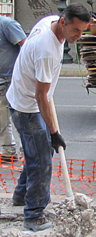 Athenian road worker repairing Athinas Street, Athens at The Cheshire Cat Blog