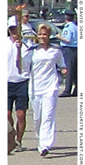 Greek athlete Giota Oikonomou carries the Olympic flame through Thessaloniki, Greece