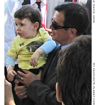Rights and Equality Party leader Osman Pamuköglu holds a child in Selcuk, Turkey