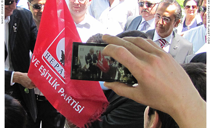 Rights and Equality Party member photographs the leader Osman Pamuköglu in Selcuk, Turkey at The Cheshire Cat Blog