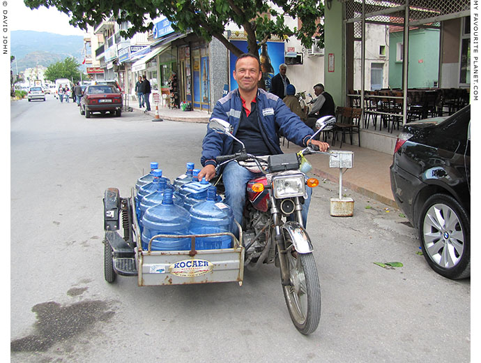 A water delivery man on a motorbike and sidecar in Söke, Turkey at The Cheshire Cat Blog