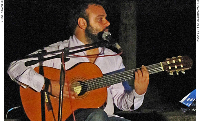 Guitarist playing traditional Cretan music in Pella, Greece at The Cheshire Cat Blog