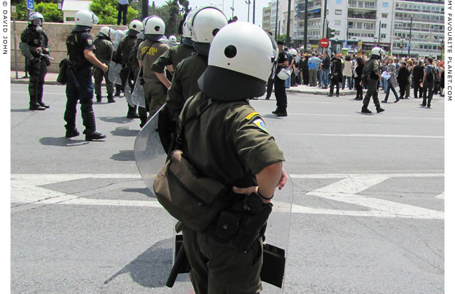 Athens riot police ready for action in Syntagma Square at the Mysterious Edwin Drood's Column