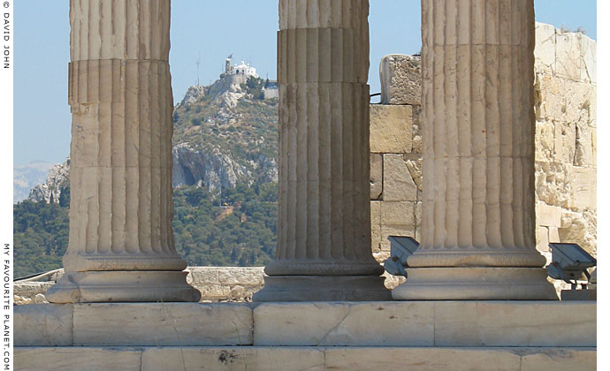 Ionic column bases of the Erechtheion, with Lykavittos Hill in the background at My Favourite Planet