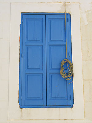 An old blue shuttered window in Kastellorizo, Greece at My Favourite Planet