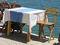 Quayside restaurant table in Kastellorizo harbour, Greece at My Favourite Planet Quayside restaurant table in Kastellorizo harbour, Greece at My Favourite Planet