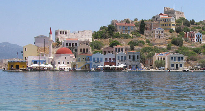 The east side of Kastellorizo harbour: the Kavos headland and Nikolaou Savva Square, Greece at My Favourite Planet
