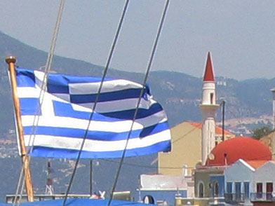 The Greek flag flies on a boat in Kastellorizo harbour, Greece at My Favourite Planet