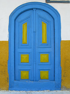 The blue and yellow door of Pantopoleion Potion drinks store, Kastellorizo, Greece at My Favourite Planet