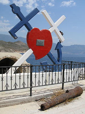 Heart with crossed anchor and crucifix, symbol of the Megisti, Kastellorizo, Greece at My Favourite Planet