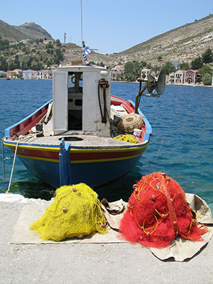 Fishing boat with its nets left to dry in Kastellorizo harbour, Greece at My Favourite Planet