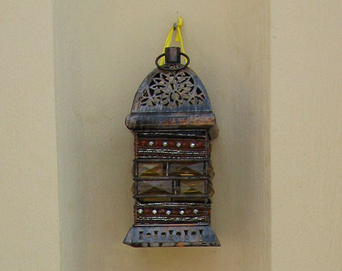 Lantern hanging in a wall niche near the harbour front, Kastellorizo, Greece at My Favourite Planet