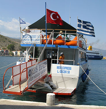 The Turkish and Greek flags fly side by side on the Meis Express ferry in Kastellorizo harbour, Greece at My Favourite Planet The Turkish and Greek flags fly side by side on the Meis Express ferry in Kastellorizo harbour, Greece at My Favourite Planet