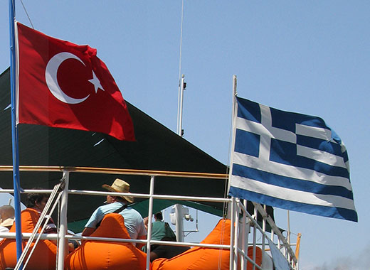 The Turkish and Greek flags flying side by side on the Meis Express ferry in Kastellorizo harbour, Greece at My Favourite Planet