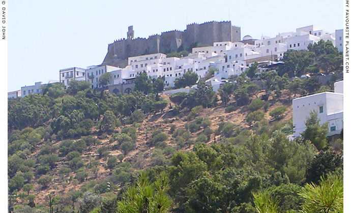 The whitewashed houses of Hora village clustered beneath the Monastery of Saint John, Patmos, Greece at My Favourite Planet