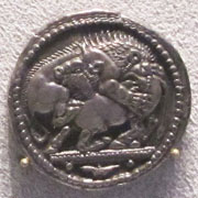 Silver tetradrachm of Akanthos, depicting a lion attacking a bull