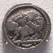 Silver tetradrachm of Akanthos, depicting a lion attacking a bull Silver tetradrachm of Akanthos, depicting a lion attacking a bull