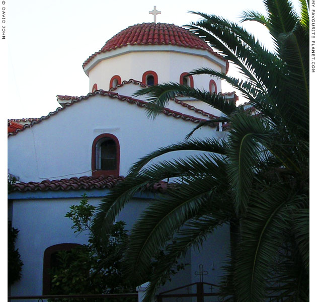 A church in Chora, Samos, Greece, surrounded by trees and houses at My Favourite Planet