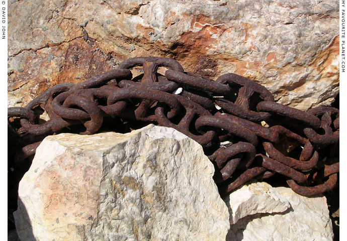 An old anchor chain wrapped around a rock in Kokkari harbour, Samos, Greece at My Favourite Planet