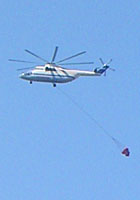 A fire-fighting helicopter flies over Kokkari, Samos, Greece at My Favourite Planet