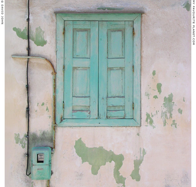 Wooden window shutters and matching electricity meter of a house in Kokkari, Samos, Greece at My Favourite Planet