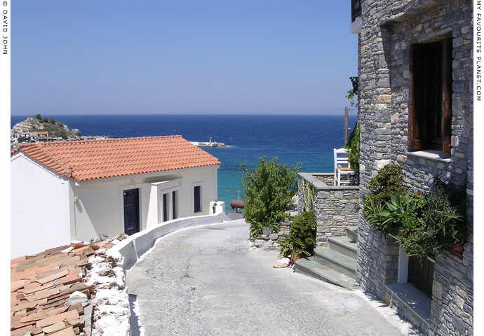 The street down from the main road to the east side of Kokkari harbour, Samos, Greece at My Favourite Planet