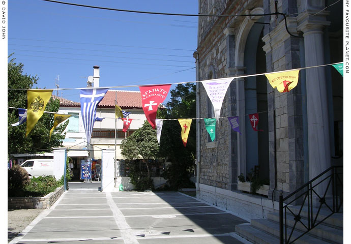Festive bunting in the churchyard of Agios Nikolaos Church, Kokkari, Samos, Greece at My Favourite Planet
