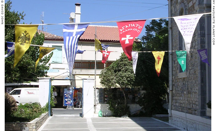 Religious pennants in the churchyard of Agios Nikolaos Church, Kokkari, Samos, Greece at My Favourite Planet