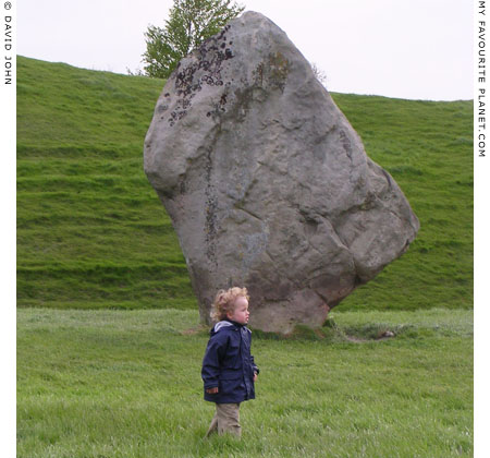 Young visitor inspects the megaliths on the southwest sector of the outer circle of Avebury Henge, Wiltshire at My Favourite Planet