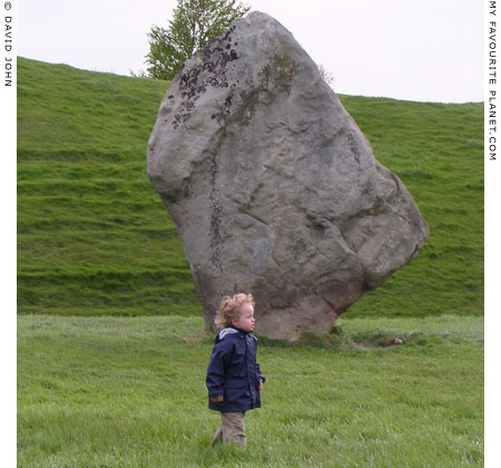 Young visitor inspects the megaliths on the southwest sector of the outer circle of Avebury Henge, Wiltshire at My Favourite Planet Young visitor inspects the megaliths on the southwest sector of the outer circle of Avebury Henge, Wiltshire at My Favourite Planet