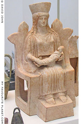 Terracotta figure of a seated woman holding a baby from Thebes, Greece Terracotta figure of a seated woman holding a baby from Thebes, Greece