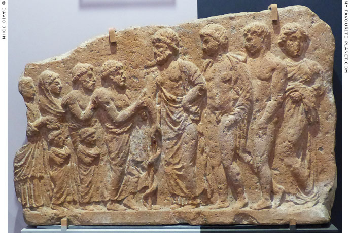 Terracotta votive relief of a family presenting offerings to Asklepios and his children at My Favourite Planet