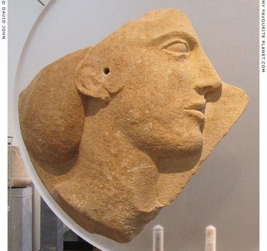 A relief of a female head on a fragment of a marble disc from Melos at My Favourite Planet