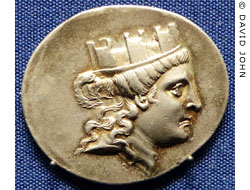 Tyche wearing a mural crown on a coin from Smyrna at My Favourite Planet