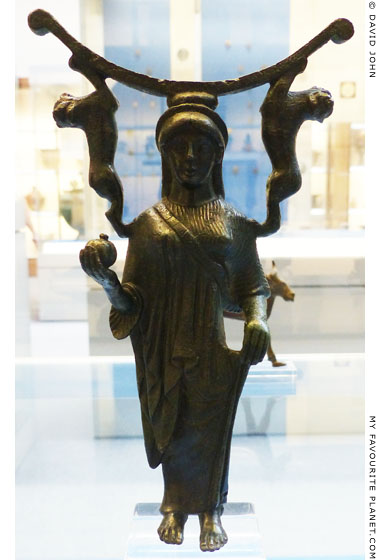 Bronze mirror support in the form of a female figure holding a pomegranate at My Favourite Planet