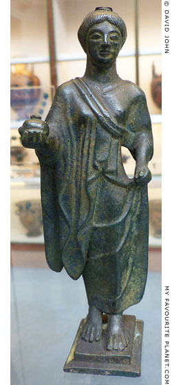 Bronze figure holding a pomegranate from Campania at My Favourite Planet