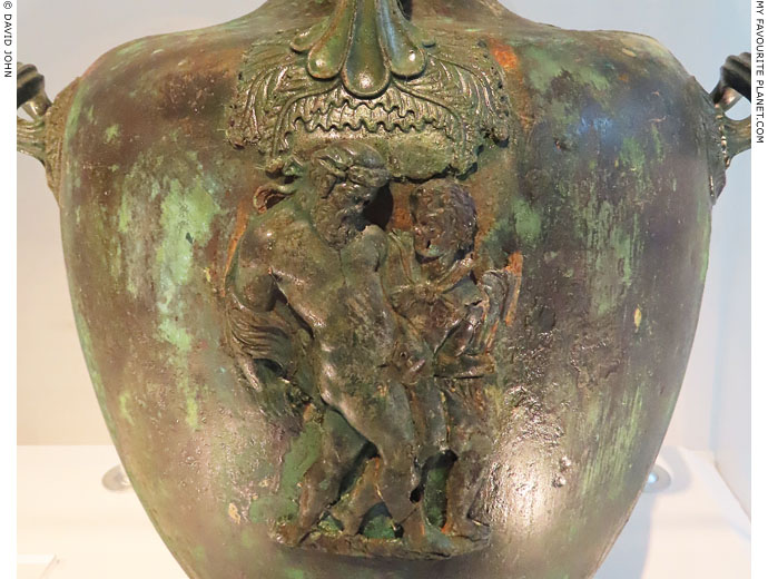 Drunken Dionysus supported by a Satyr on a bronze hydria at My Favourite Planet