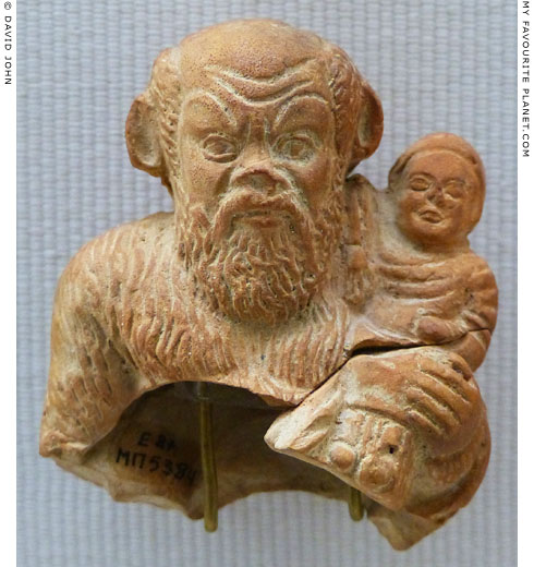 Terracotta figurine of Papposilenos holding the infant Dionysus in Piraeus at My Favourite Planet