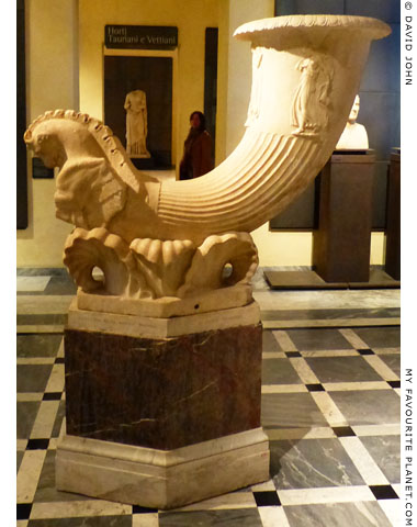 A marble fountain in the shape of a horn with a relief of dancing Maenads at My Favourite Planet