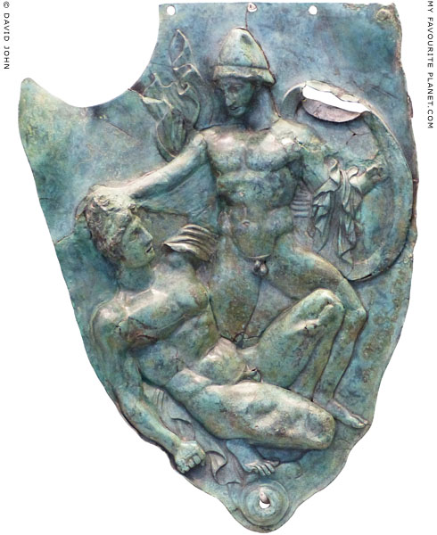 Two warriors fighting on the bronze cheekpiece of a helmet at My Favourite Planet Two warriors fighting on the bronze cheekpiece of a helmet at My Favourite Planet