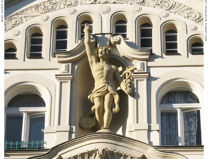 A statue of Hermes on a house facade Berlin at My Favourite Planet