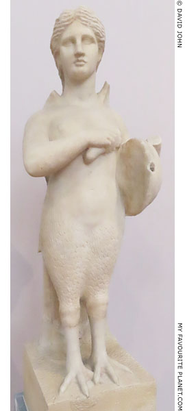 Statue of a Siren playing a lyre in Athens at My Favourite Planet Statue of a Siren playing a lyre in Athens at My Favourite Planet