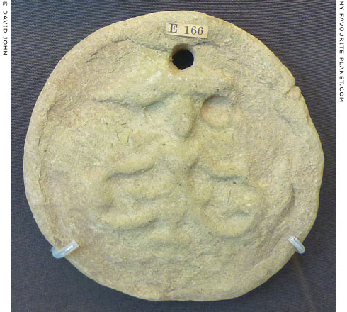 A terracotta loom weight with a depiction of Skylla at My Favourite Planet A terracotta loom weight with a depiction of Skylla at My Favourite Planet