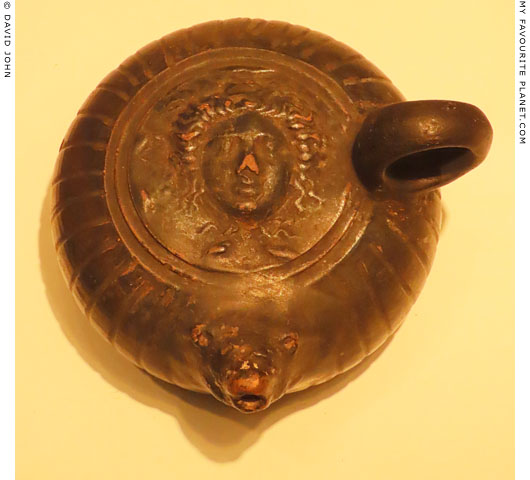 A Gorgoneion on a ceramic oil lamp at My Favourite Planet A Gorgoneion on a ceramic oil lamp at My Favourite Planet